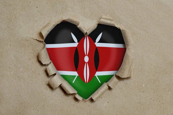 Foro Forma Cuore Strappato Attraverso Carta Mostrando Bandiera Del Kenya — Foto Stock