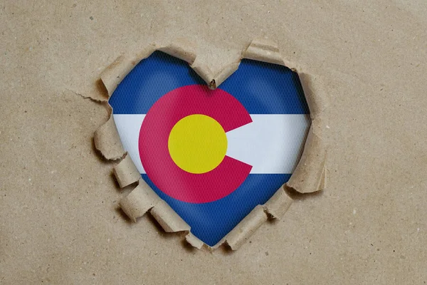 Heart Shaped Hole Torn Paper Showing Colorado Flag — Stock Photo, Image