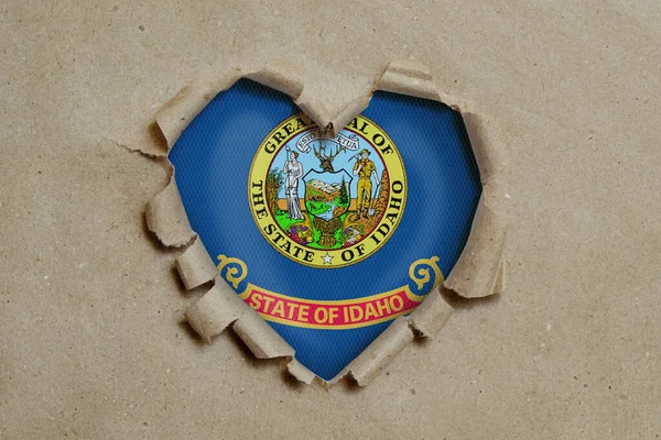 Heart Shaped Hole Torn Paper Showing Idaho Flag — Stock Photo, Image