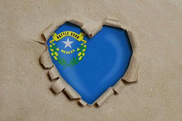 Heart Shaped Hole Torn Paper Showing Nevada Flag — Stock Photo, Image