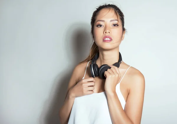 beautiful asian woman with headphones