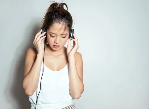 beautiful asian woman with headphones