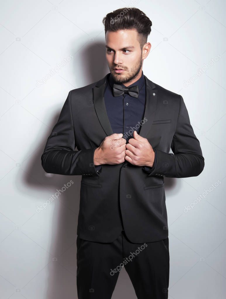 handsome young man in suit on grey background. Business man