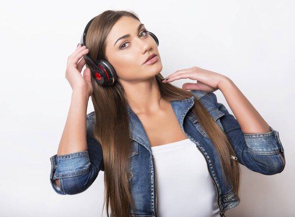 beautiful young woman with long hair listening to music with headphones