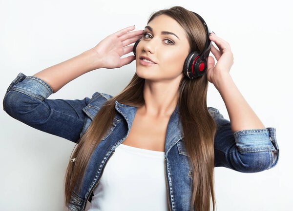 beautiful young woman with long hair listening to music with headphones