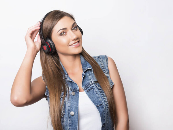 beautiful young woman with long hair listening to music with headphones