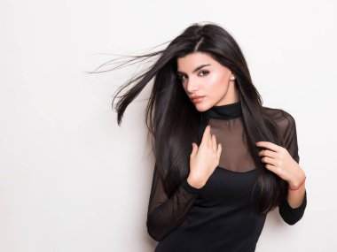 elbise ve beyaz arka plan üzerinde poz uzun siyah saçlı güzel genç kadın