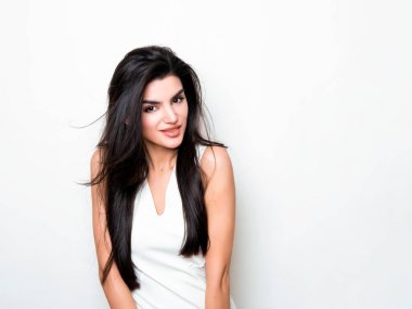 elbise ve beyaz arka plan üzerinde poz uzun siyah saçlı güzel genç kadın