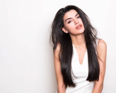 elbise ve beyaz arka plan üzerinde poz uzun siyah saçlı güzel genç kadın