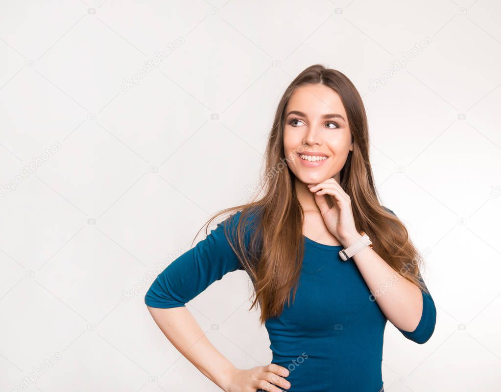beautiful young woman with long brown hair wearing wrist watch and posing in grey background with copy space