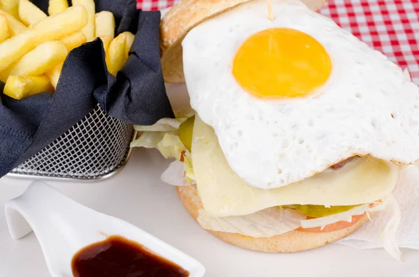 Burger with egg and French fries — Stock Photo, Image