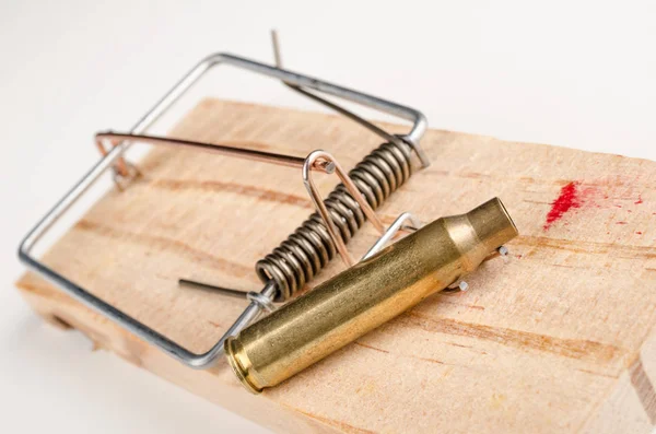 Gun violence concept, bullet in a mousetrap — Stock Photo, Image
