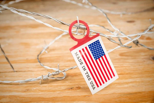 US flag on barbed wire