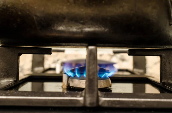 Iron pot on burning stove — Stock Photo, Image