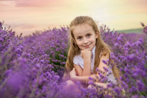 Girl in lavender field at sunset — Stock Photo, Image