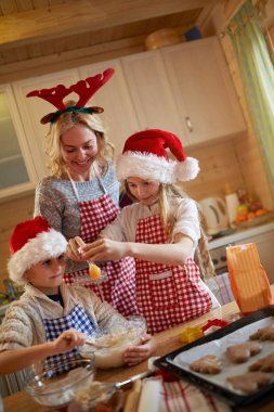 çocuklar ve anne Noel kurabiyesi yaparken zevk