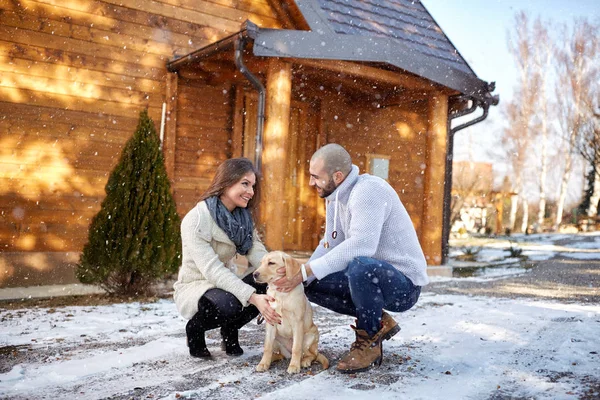 Meisje met hond en vriendje op wintersport — Stockfoto
