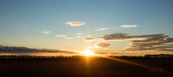 Sunset on sky with clouds — Stock Photo, Image