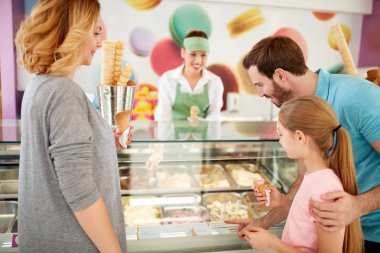 Girl with parents chooses flavors of ice cream clipart