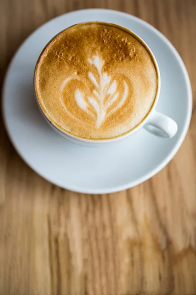 Close up of fresh cup coffee on wooden table — Stock Photo, Image