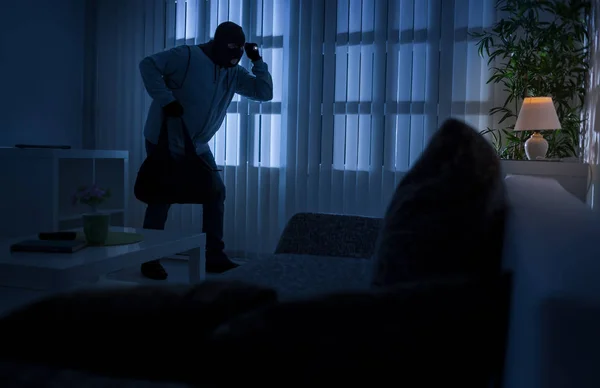 Burglary or thief breaking into a home at night through a back door — Stock Photo, Image