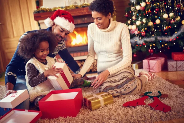 Happy family in Christmas morning opening present — Stock Photo, Image