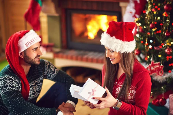 Chica sonriente abriendo regalo de Navidad — Foto de Stock