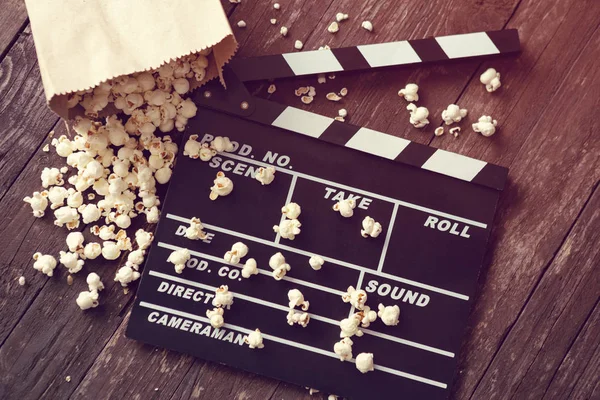 Movie clapper board with popcorn — Stock Photo, Image