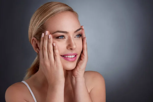 Middle age woman tightening skin on face — Stock Photo, Image