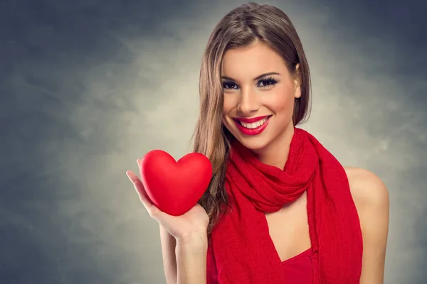 Beautiful woman holding red heart — Stock Photo, Image