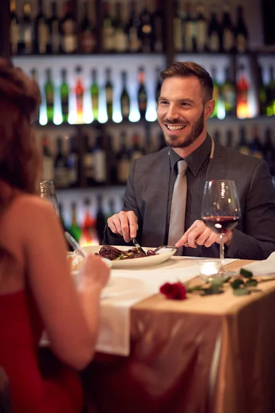 Мужчина ест в ресторане с женщиной — стоковое фото