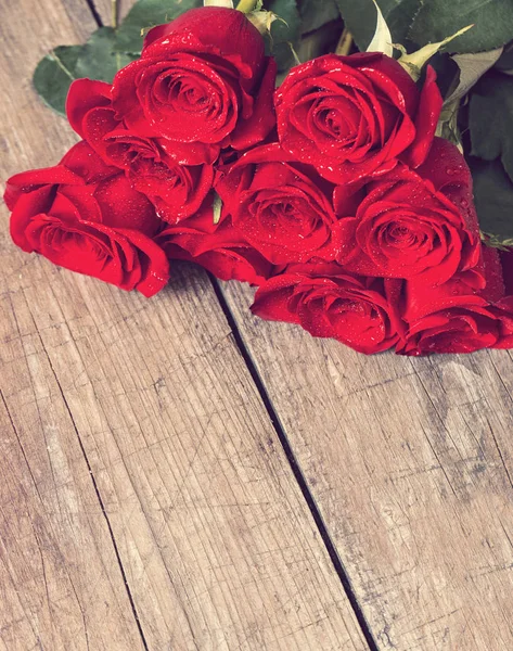 Bukett av rosor på trä skrivbord — Stockfoto