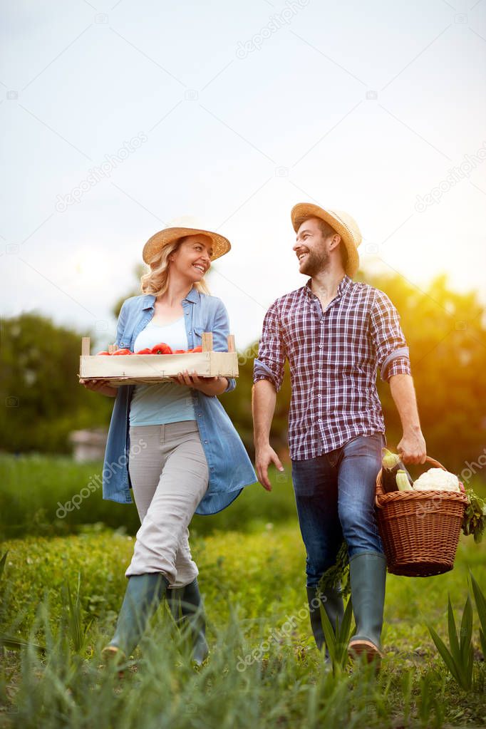 Satisfied couple returning from business in garden
