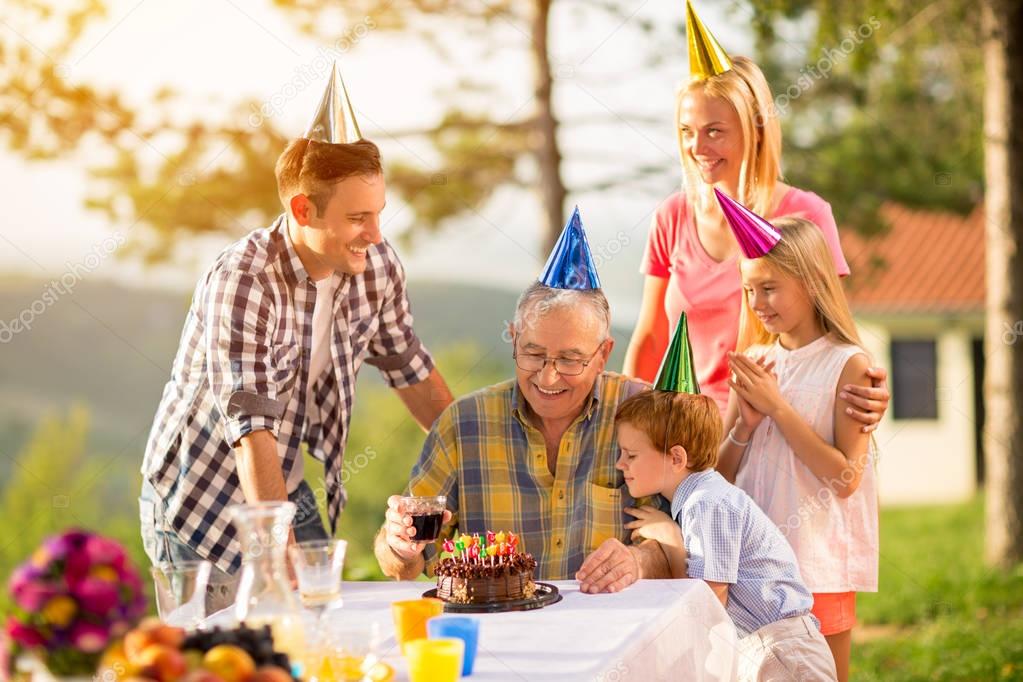 Download Grandfather on birthday with his family — Stock Photo ...