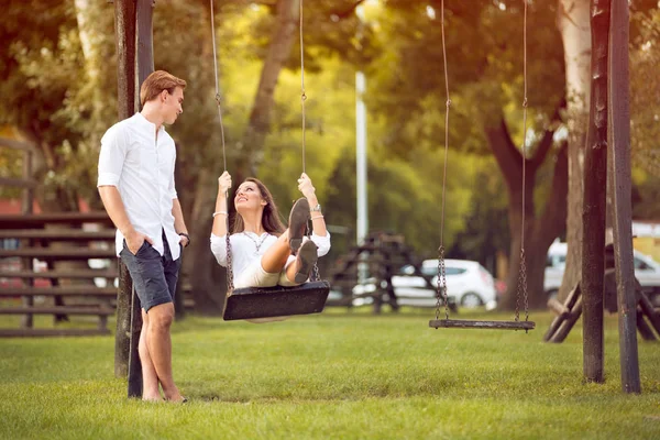 Man swinging his girl — Stock Photo, Image