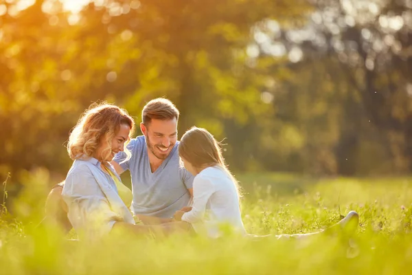 Los padres con chica en el parque verde —  Fotos de Stock