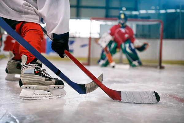 Ice hockey player in action kicking with stick — Stock Photo, Image