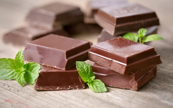 Stack of chocolate pieces with a leaf of mint
