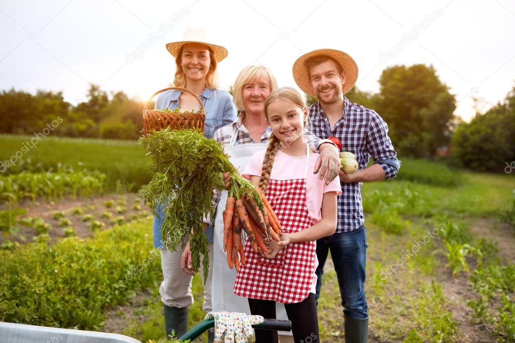 Farmers family with organic vegetables 