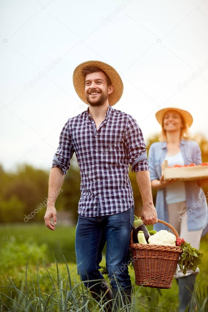 Farmer returning from garden with vegetarian products