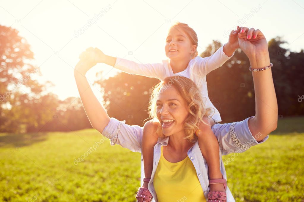 Woman with girl on shoulders