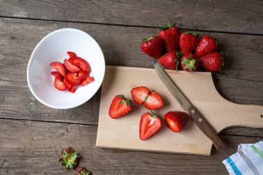 ahşap tahta üzerinde çilek dilimlenmiş