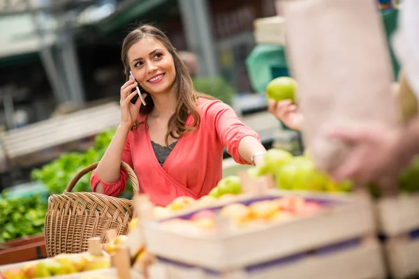 Sorrir mulher com telefone celular no mercado de rua — Fotografia de Stock