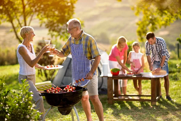 Happy grandparents drink wine — Stock Photo, Image