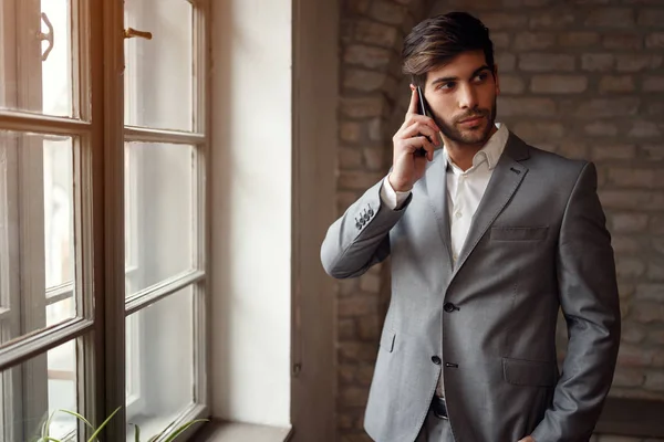 Hombre de negocios de éxito en traje con teléfono inteligente —  Fotos de Stock