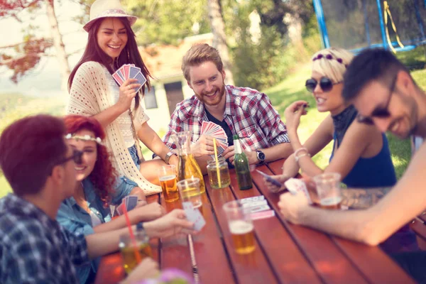 Female and male play cards in nature — Stock Photo, Image