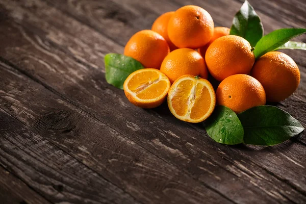 Freshly harvested orange on wooden background — Stock Photo, Image