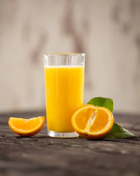 Fresh orange drink on wooden table. Fruit orangeade. Summer drink