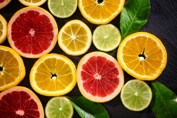 Juicy fruit background from various slices of citrus — Stock Photo, Image