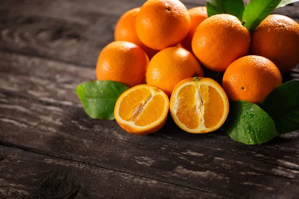 Sweet fresh oranges and half of orange on the wooden — Stock Photo, Image
